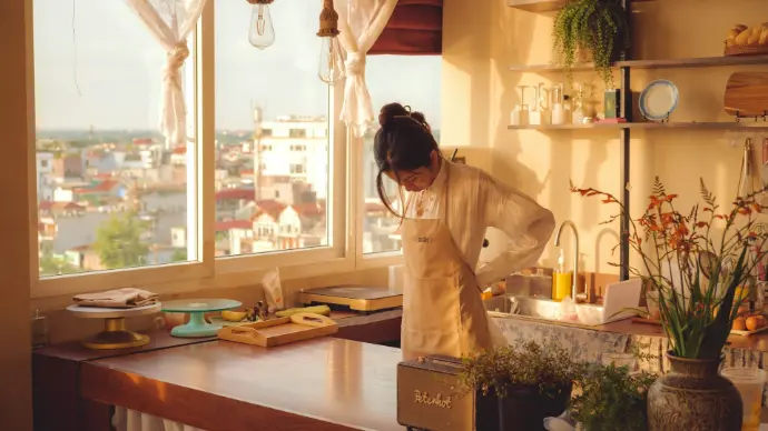 A woman standing in a kitchen next to a window